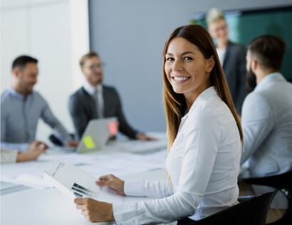 Business Woman Smiling in Group Meeting